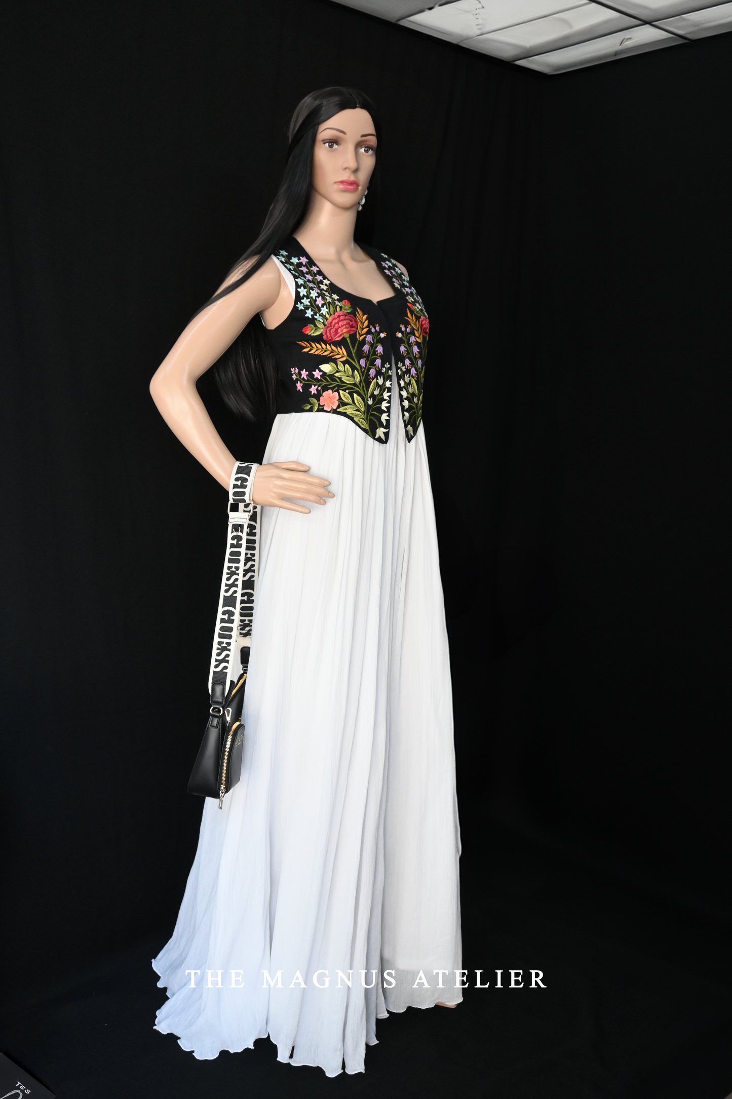Front view of elegant white maxi dress with black embroidered linen jacket for women