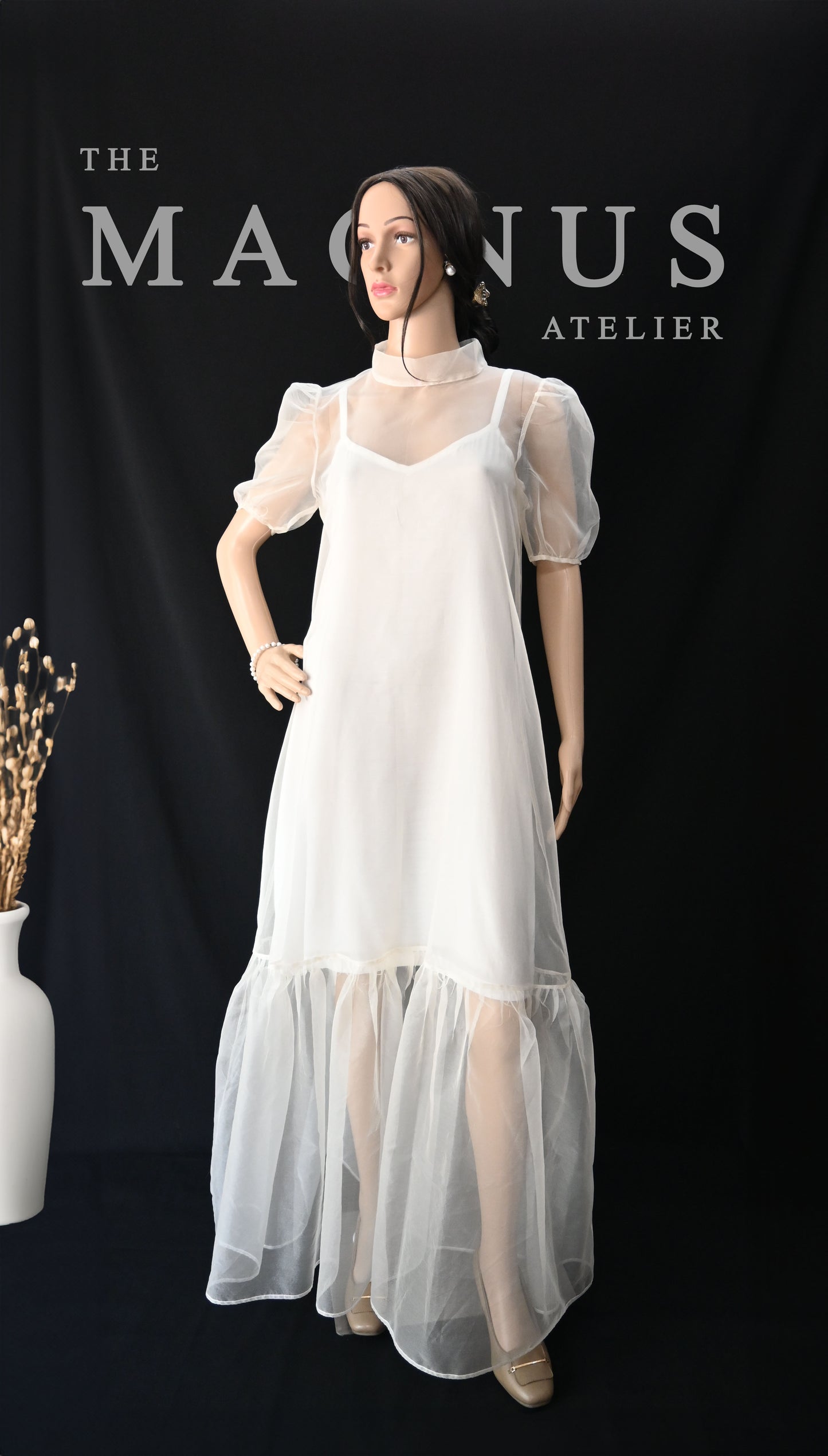 Ethereal fashion editorial shot of white organza dress with high neck and puff sleeves by The Magnus Atelier