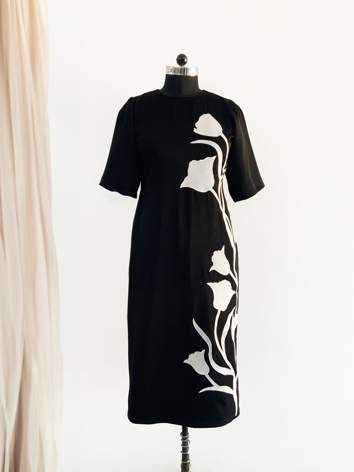Close-up of floral tulip embroidery on dress