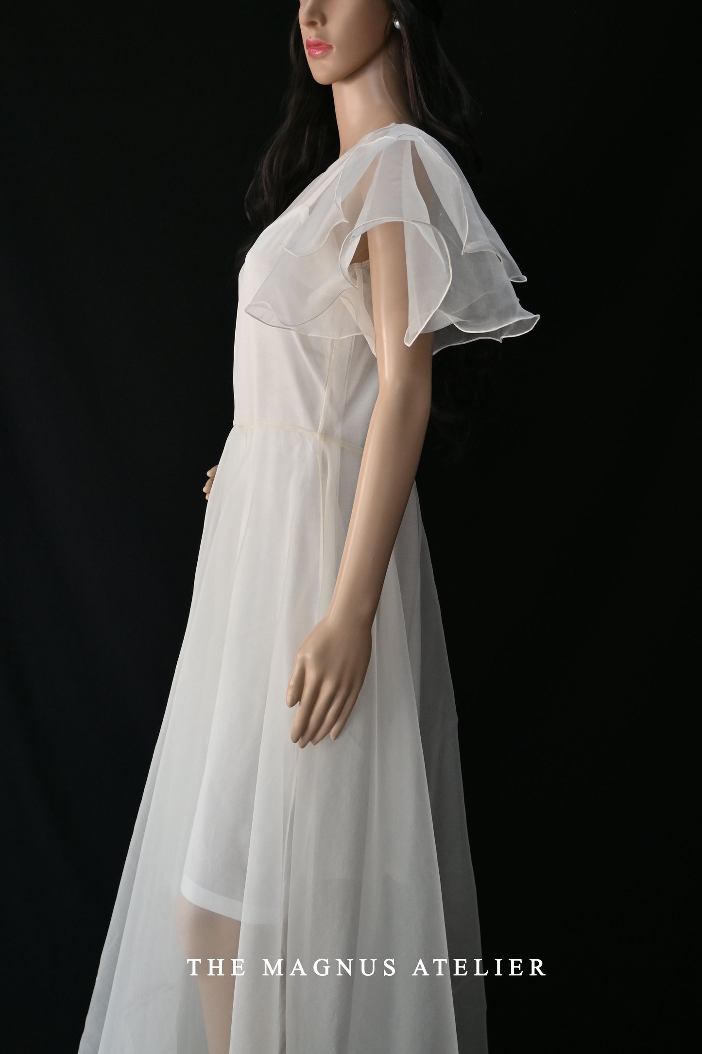 side view of a white flowy airy organza dress with circular flare