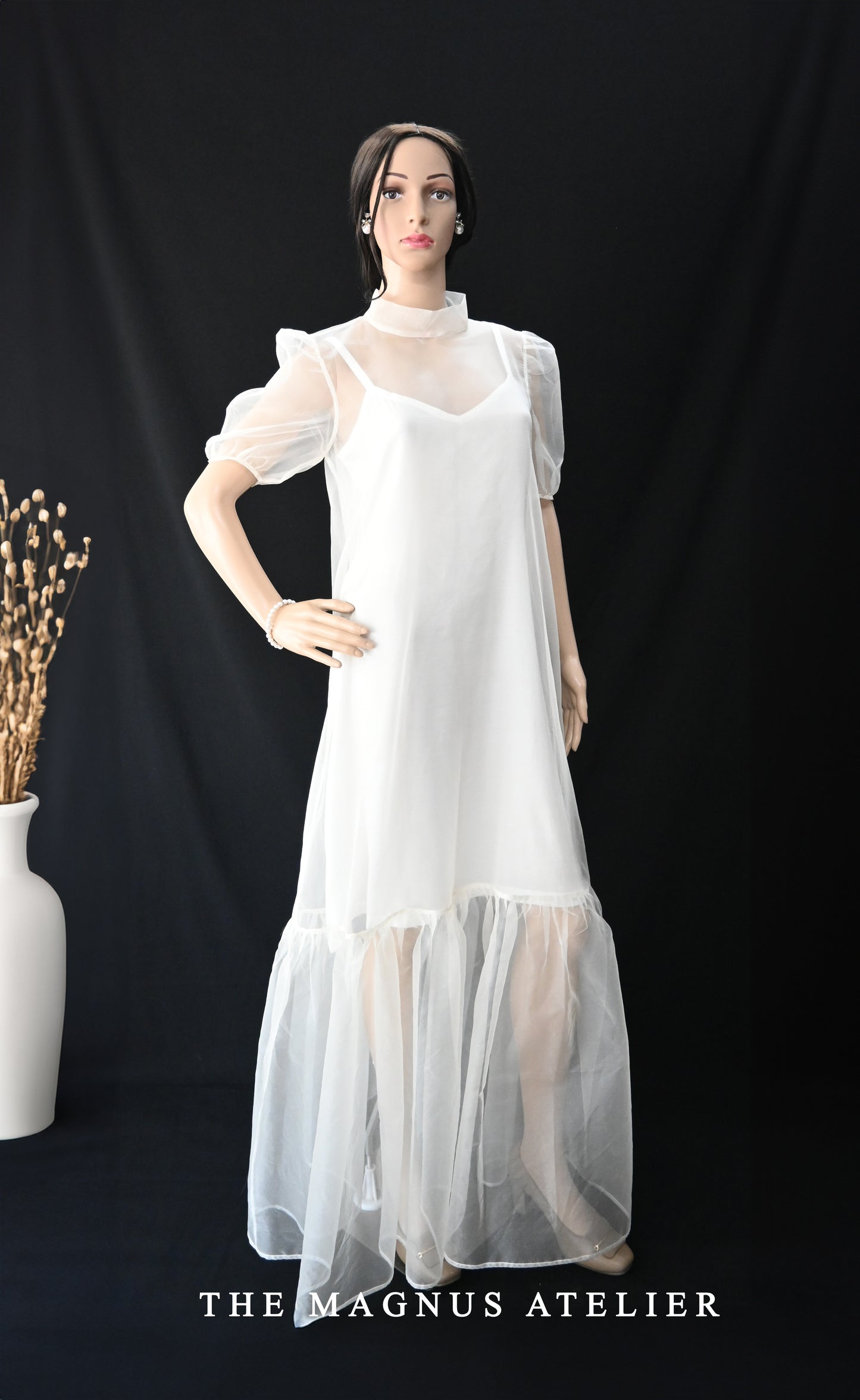 Side profile view of The Magnus Atelier’s white maxi dress in soft sheer organza fabric