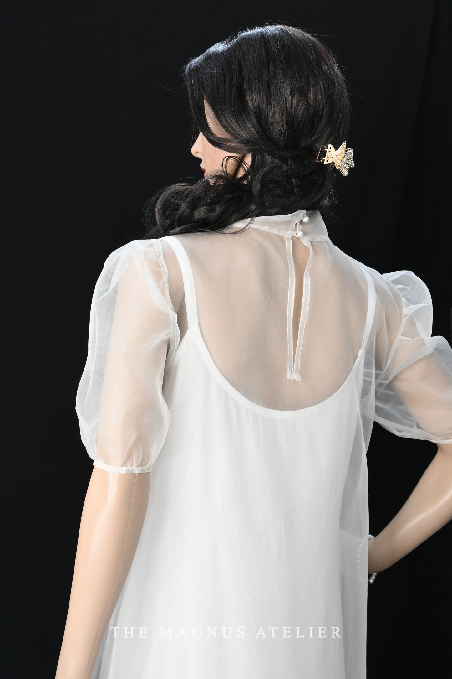 Front view of elegant white organza maxi dress with puff sleeves and ruffled hem by The Magnus Atelier