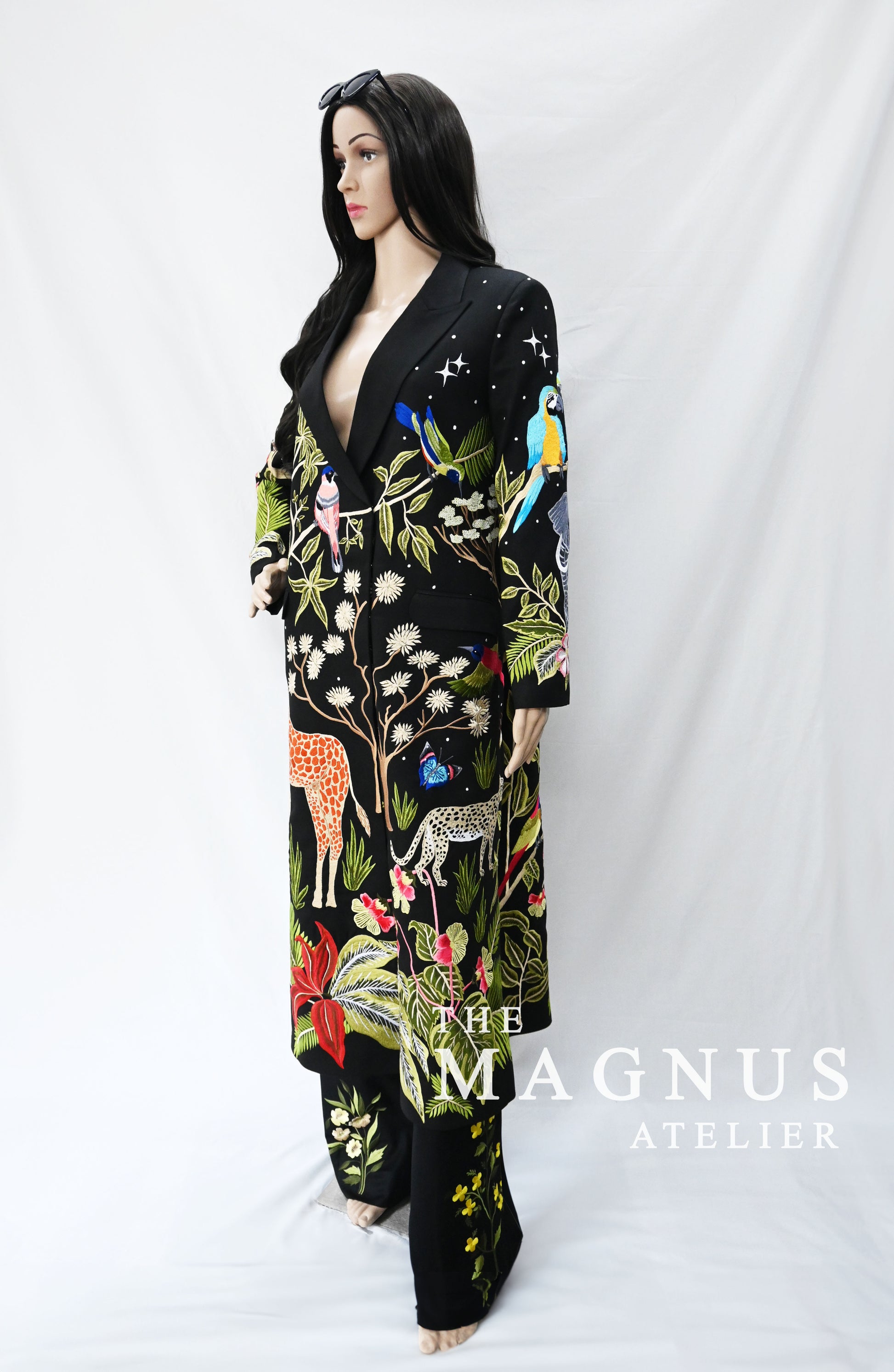 Close-up of detailed embroidery featuring animals and tropical plants on black blazer set