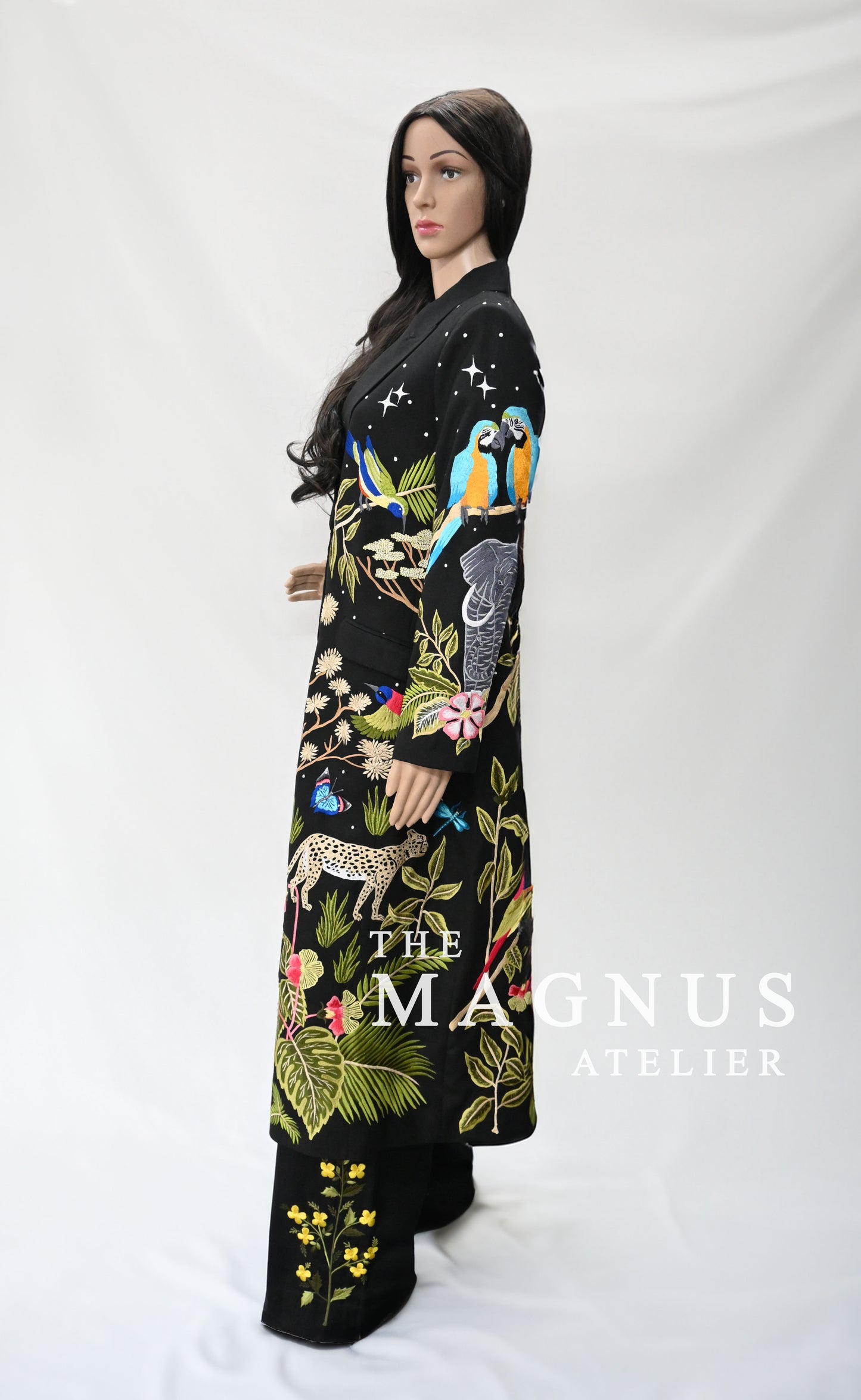 Side profile of black embroidered jungle-themed women's blazer with parrots, elephant, and leaves