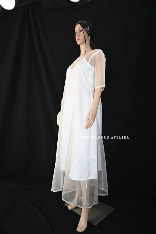 White sheer overlay dress on mannequin with inner slip