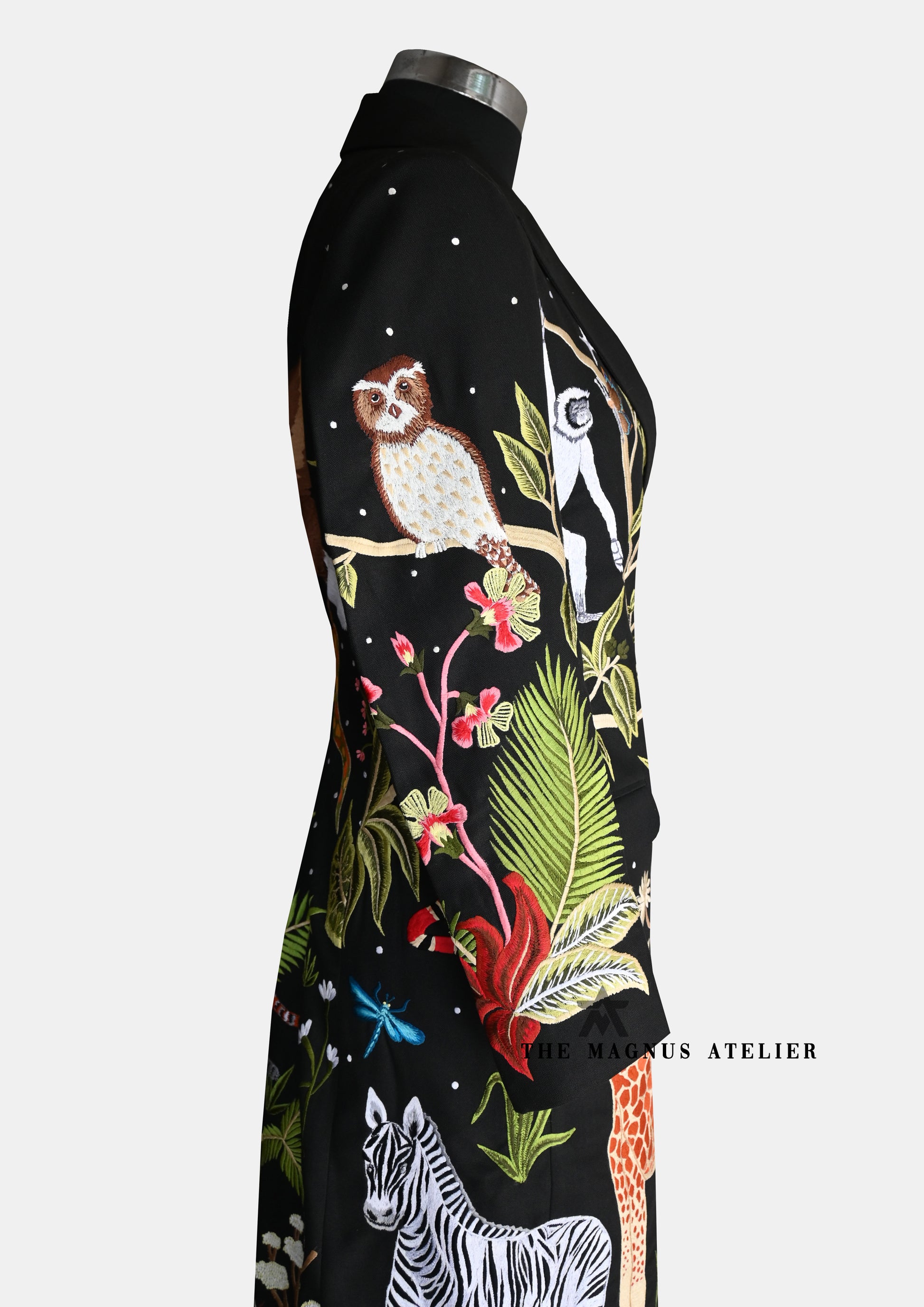 owl and zebra detailing on embroidered coat sleeves