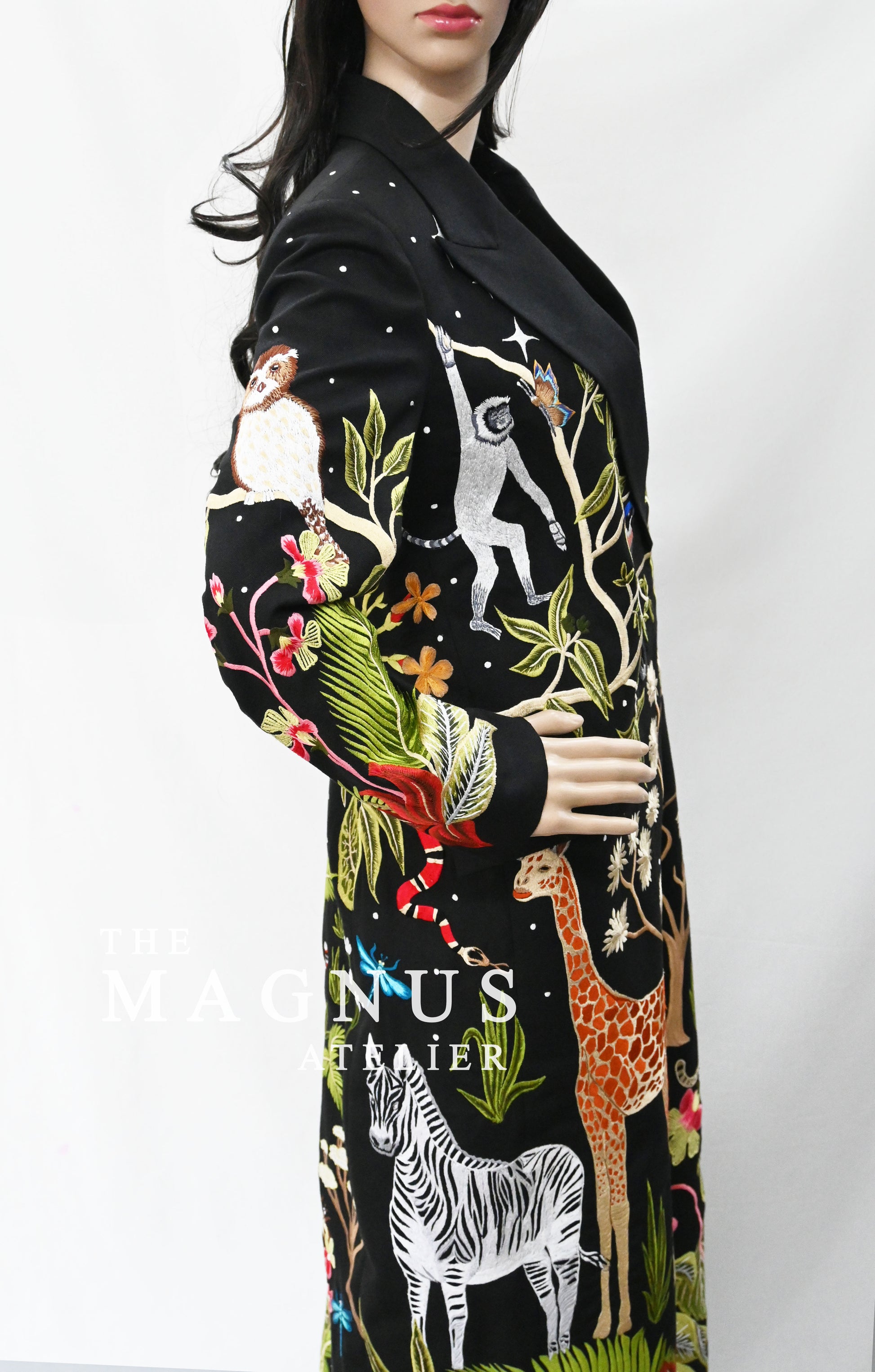 Close-up of detailed embroidery featuring animals and tropical plants on black blazer set